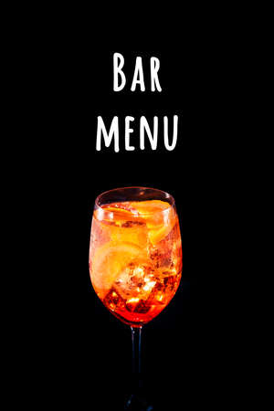 Stylish alcoholic trendy cocktail with orange slice on black background. Vertical photo.. Bar menu wordingの写真素材