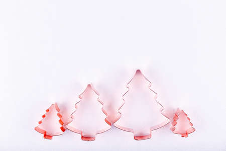 Flatlay with family of holiday tree cookie cutters on sparkling background. Holiday, Christmas and New Year concept. Flat lay, top view backgroundの写真素材
