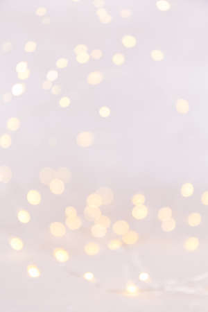 White background with bokeh lights. Holiday Christmas and New Year background. Verticalの写真素材