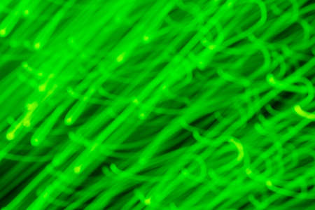 Futuristic blurred lights holiday monochrome background in bright green neon. Horizontal, soft focusの写真素材