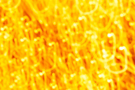 Futuristic blurred lights holiday monochrome background in yellow. Horizontal, soft focusの写真素材