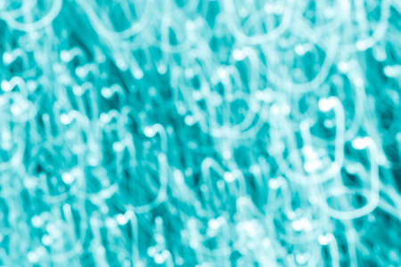 Futuristic blurred lights holiday monochrome background in turquoise. Horizontal, soft focusの写真素材