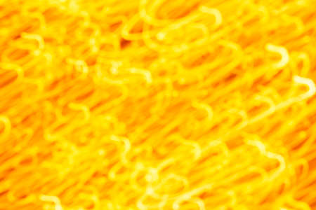 Futuristic blurred lights holiday monochrome background in yellow. Horizontal, soft focusの写真素材