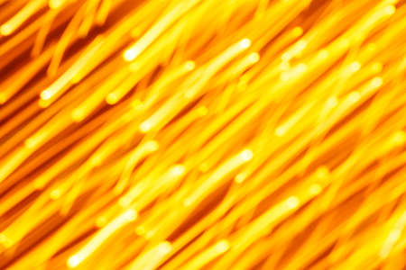 Futuristic blurred lights holiday monochrome background in yellow. Horizontal, soft focusの写真素材