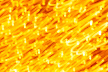 Futuristic blurred lights holiday monochrome background in yellow. Horizontal, soft focusの写真素材