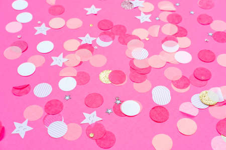 Multicolor pink, gold and white confetti on the bold pink background, holiday celebration backdrop, Flat lay styleの写真素材