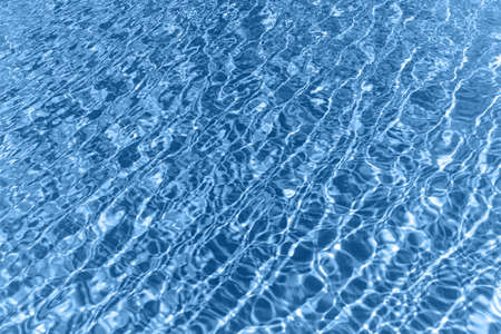 Surface of blue shining swimming pool water ripple. Can be used as background.の写真素材