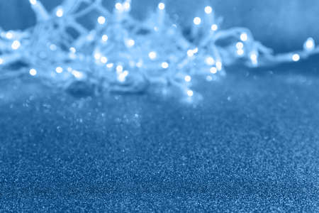 Holiday blue background with lights and bokeh. Christmas and New Year party concept. Stylish trendy holiday season. Horizontalの写真素材