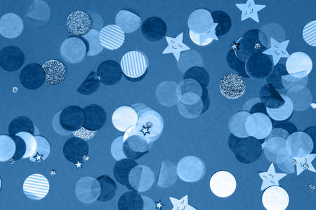 Monochrome blue and white confetti on the bold blue background, holiday celebration backdrop, Flat lay styleの写真素材