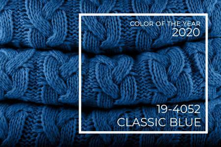 Saturated jeans blue knits pile with color tag. Warm cozy home and fashion colors concept. Horizontalの写真素材