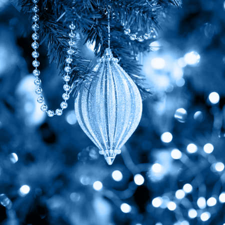 Seasonal background with Christmas toy on the tree. Celebration concept. Soft focus, blue toning. Squareの写真素材