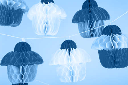 Paper cupcakes celebration decoration. Holiday party concept in classic blue. Horizontalの写真素材