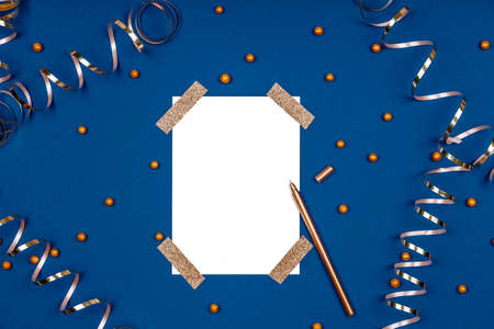Isolated white card mock up with festive golden ribbons and confetti. Flat lay background in gold and classic blue colors for any celebration and party occasion. Horizontalの写真素材