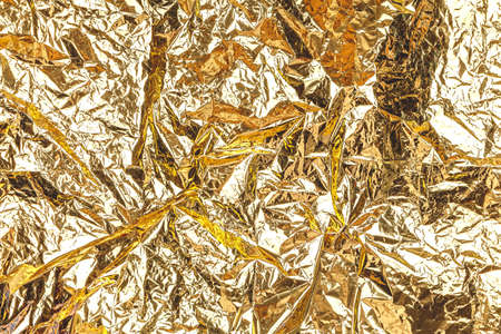 Shimmering destructured golden foil background. Perfect background for any holiday project, place for text. Horizontalの写真素材