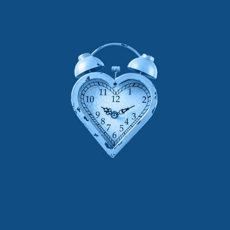 Heart shaped clock on solid background toned in classic blue. Valentines day and love infitity and duration concept. Squareの写真素材