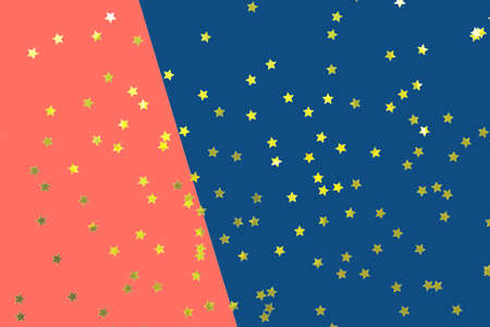 Double color blue and coral modern flat lay backgound. Top view, flat lay. Horizontal with festive golden star shaped confettiの写真素材