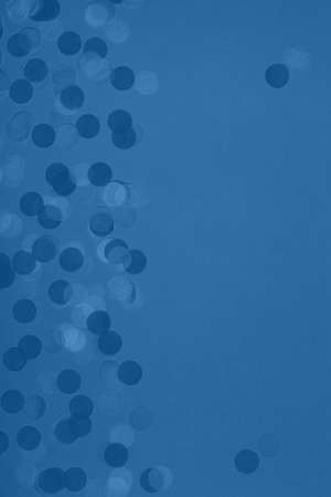 Creative pastel fantasy holiday card with party confetti in classic blue. Baby shower, birthday, celebration concept. Verticalの写真素材