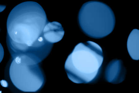 Black background with classic blue bokeh lights. Holiday, Christmas and New Year background. Horizontal, perfect for layeringの写真素材