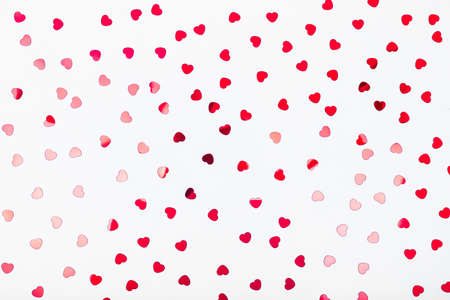 Grey background with red glitter heart confetti. Valentine day concept. Trendy minimalistic flat lay design background. Horizontalの写真素材