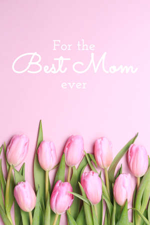 For the best Mom ever wording with pink tulips on the pink background. Flat lay, top view. Mothers day holiday celebration card. Verticalの写真素材