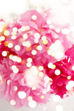 Paper flowers at the girl baby shower party. Baby shower celebration concept. Festive party background. Vertical with festive holiday bokehの写真素材