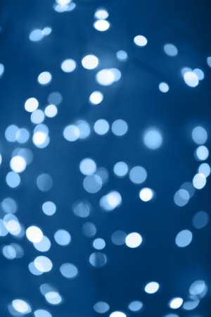 Black background with classic blue bokeh lights. Holiday, Christmas and New Year background. Horizontal, perfect for layeringの写真素材