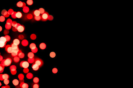 Black background with bright red warm bokeh lights. Holiday, Valentines, Christmas and New Year background. Ideal to layer with any design. Horizontalの写真素材