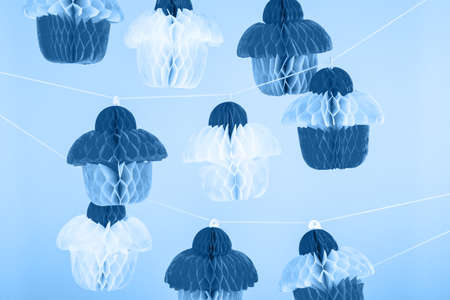 Paper cupcakes celebration decoration. Holiday party concept in classic blue. Horizontalの写真素材