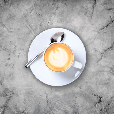 Overhead view of cafe latte with craft design on it on the grey marble surface. Squareの写真素材