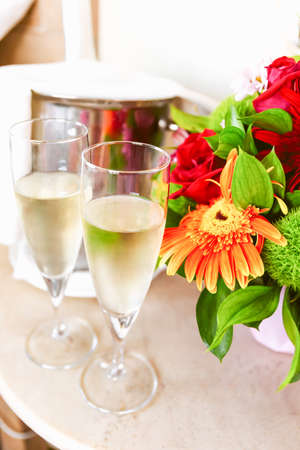 Two glasses of champagne in the upscale hotel room. Dating, romance, honeymoon, valentine, getaway concepts. Verticalの写真素材