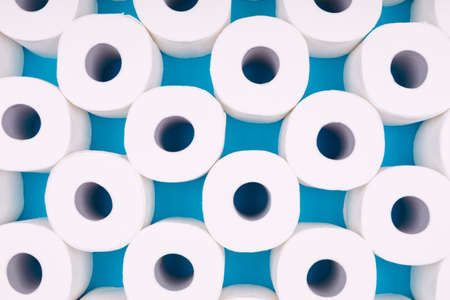 Pattern of toilet paper rolls on the bright blue background. Coronavirus pandemic panic shopping concept. Bright monochrome dropの写真素材