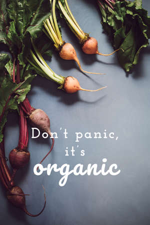 Mix of red and gold beets on grey background with Organic Produce wording. Food background. Concept of healthy eating. Toned image. Verticalの写真素材