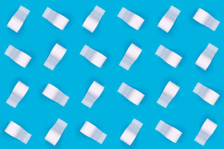 Pattern of toilet paper rolls on the bright blue background. Coronavirus COVID-19 pandemic panic shopping, social distancing concept. Bright monochrome dropの写真素材