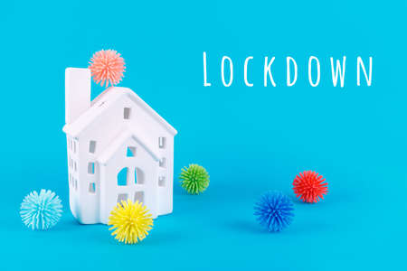 Cute little house and plastic balls aka viruses on the blue background with Lockdown wording. Epidemic, social isolation, coronavirus COVID-19 concept. Option with textの写真素材
