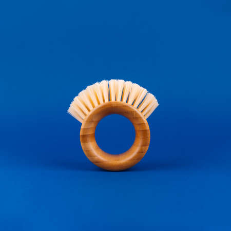 Modern futuristic round bamboo brush for fruits and vegetables on classic blue. Safe cleaning and...