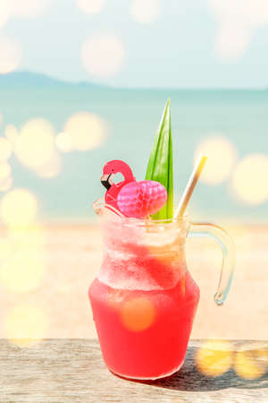 Colorful watermelon mocktail at the beach bar with sea background. Vacation, get away, summer outing concept. Bokeh effectsの写真素材