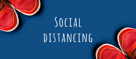 Sneakers on the solid classic blue backdrop. Keep fit athletic and healthy sports, stay home fit, virtual gym, isolation concept. Banner format, top viewの写真素材