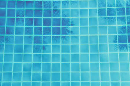 Palm trees reflection in the turquoise pool. Multipurpose backdrop. Luxuty vacation, relaxation,...