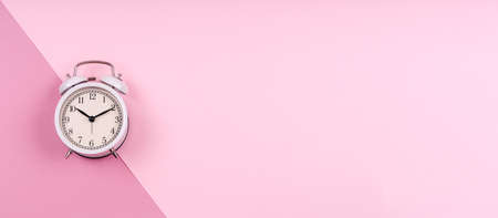 Cute white retro clock on pastel pink duotone drop. Beauty time, selfcare, feminine planning, work and life balance, getting ready concept. Place for text, banner formatの写真素材