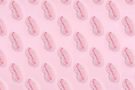Pattern of cute pink fluffy sleep mask on pink drop. Sleep management and optimization, beauty sleep, beauty and sleep log concept. Place for textの写真素材