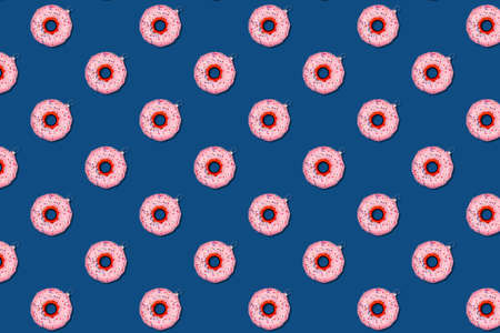 Seamless pattern with Christmas tree toy donut on classic blue. Holiday season concept, place for textの写真素材