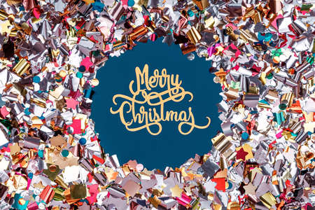 Round confetti frame with Merry Christmas paper wording on classic blue. Perfect background for any holiday season project, place for text. Horizontalの写真素材