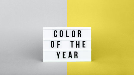 Retro lightbox with Color of the year wording on the trendy solid yellow and gray backdrop in banner format, place for textの写真素材