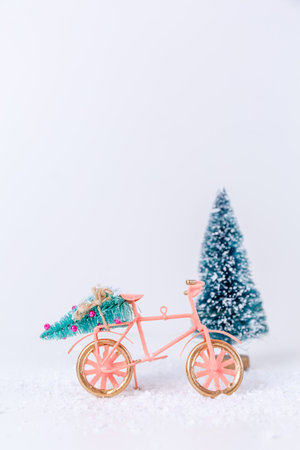 Bicycle with Christmas tree in the snow on white background. Holiday season, Christmas, Holiday celebration card conceptの写真素材