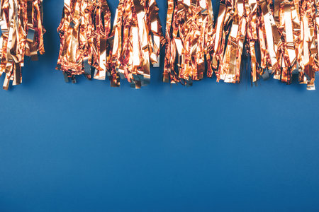 Festive golgen foil garland on classic blue. Perfect background for any holiday, celebration, special gate, victory project, place for text. Horizontalの写真素材