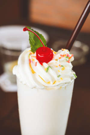 Dairy free healthy shake on the wooden table. Online menu item. Healthy treat, online order, delivery, summer sweet concept. Soft focusの写真素材