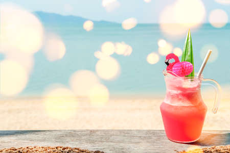 Colorful watermelon mocktail at the beach bar with sea background. Vacation, get away, summer outing concept. Bokeh effectsの写真素材