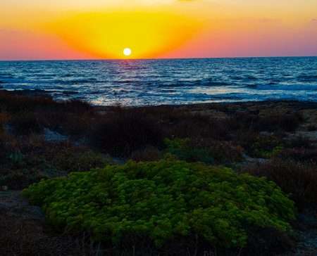 Red sunset over beach near Mediterranean sea in Cyprusの写真素材
