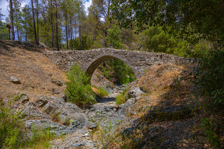 Old stone bridge for pedestrians in Cyprus mountainsの写真素材