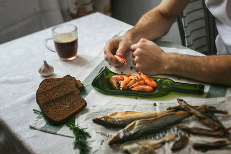Only hands. Man finishing her plate and almost ready to serve at the table. Decoration of the table. Serving dishes. Eating in beautiful dishes. Russian feastの写真素材
